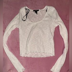White long sleeve ribbed crop top with lettuce hem.